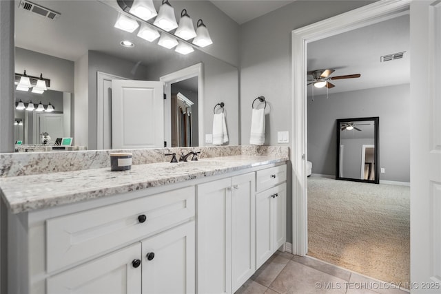 bathroom with vanity, baseboards, visible vents, and tile patterned flooring