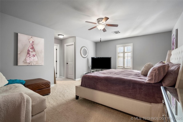 carpeted bedroom with a ceiling fan, baseboards, and visible vents