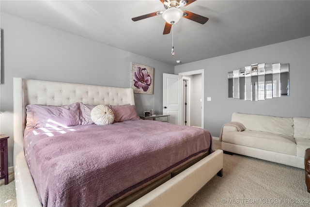 carpeted bedroom featuring baseboards and a ceiling fan