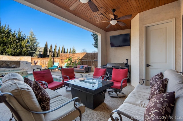 view of patio with an outdoor living space with a fire pit and fence