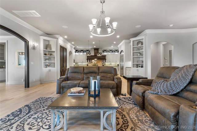 living area with visible vents, recessed lighting, arched walkways, light wood-style floors, and crown molding