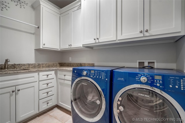 laundry room with washer and dryer, light tile patterned floors, cabinet space, and a sink