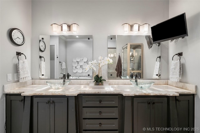 bathroom featuring a sink and double vanity