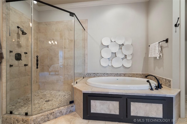 bathroom with tile patterned flooring, a shower stall, a garden tub, and crown molding