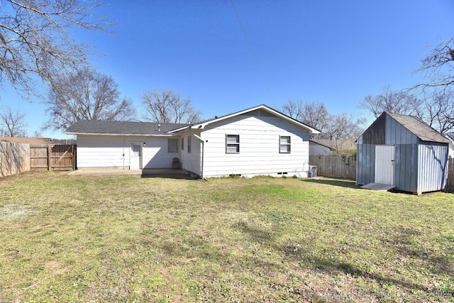 back of property featuring an outbuilding, a lawn, a fenced backyard, a shed, and cooling unit