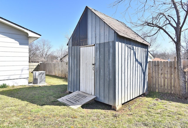 view of shed featuring cooling unit and a fenced backyard