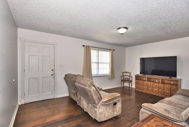 living area with a textured ceiling, baseboards, and wood finished floors