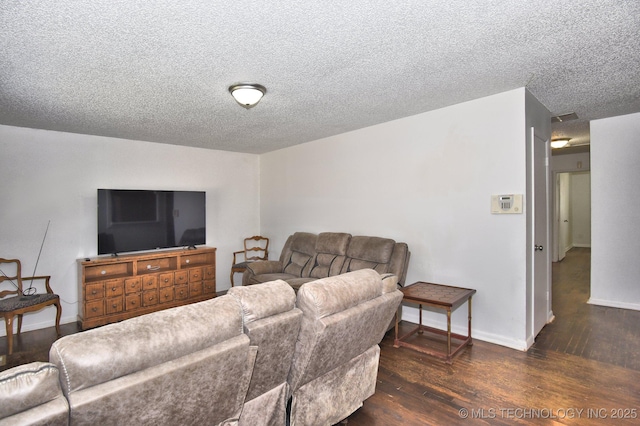 living area featuring dark wood-style floors, a textured ceiling, and baseboards