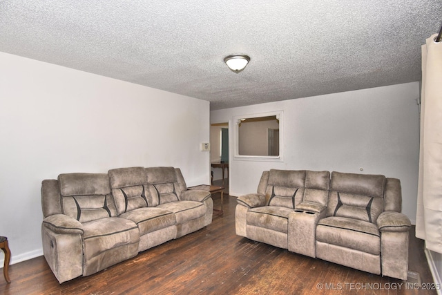 living area with a textured ceiling and hardwood / wood-style flooring