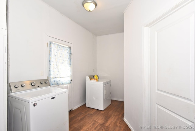 laundry area with laundry area, baseboards, dark wood-type flooring, and washing machine and clothes dryer