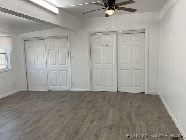 unfurnished bedroom with a ceiling fan, wood finished floors, and baseboards