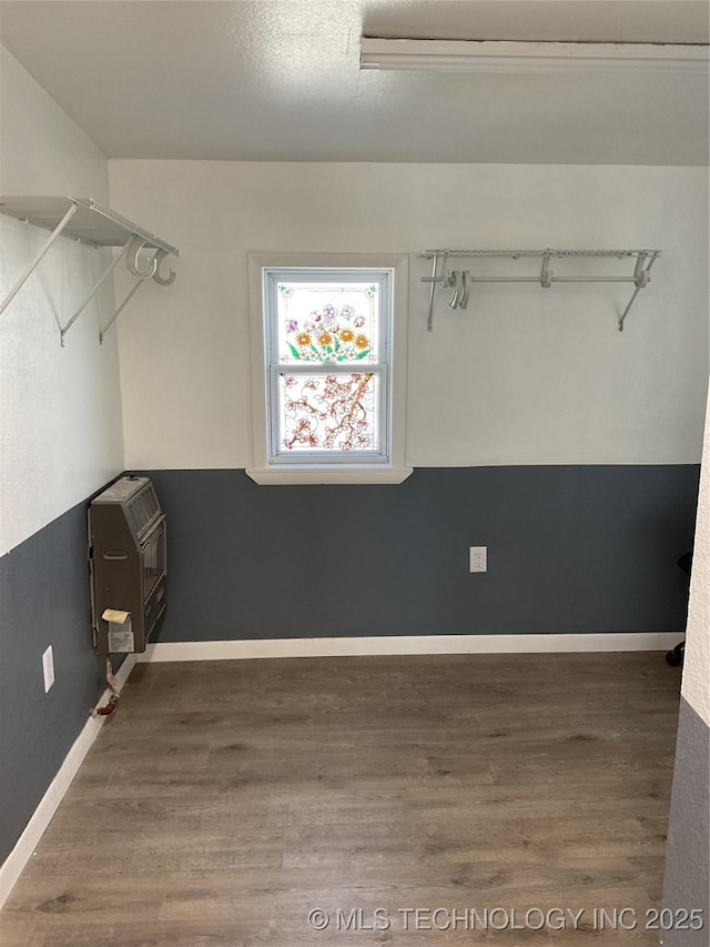 interior space featuring heating unit and wood finished floors