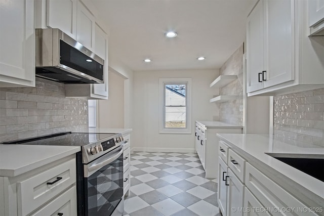 kitchen featuring open shelves, white cabinetry, appliances with stainless steel finishes, light countertops, and light floors