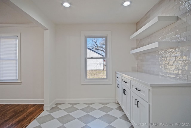 interior space with recessed lighting, light floors, and baseboards