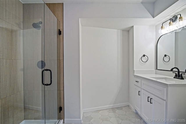 full bath featuring a stall shower, vanity, and tile patterned flooring