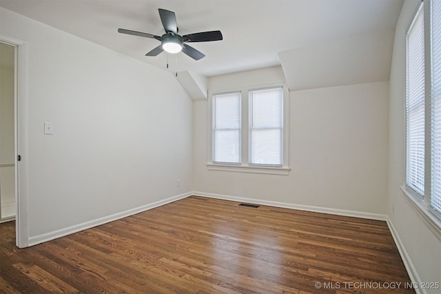 interior space featuring baseboards, dark wood-style floors, visible vents, and a healthy amount of sunlight