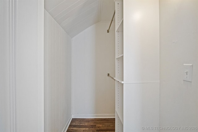 spacious closet featuring lofted ceiling and dark wood-style flooring