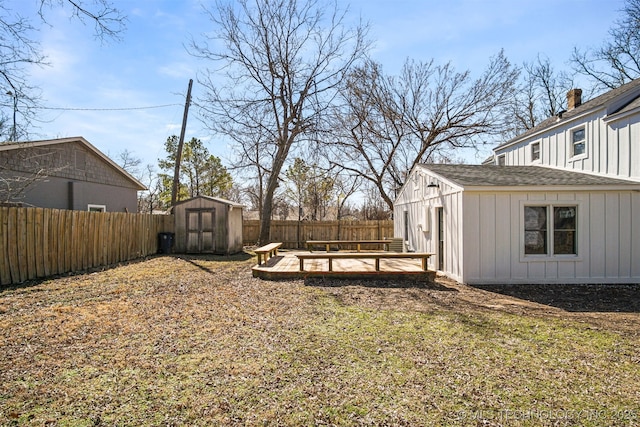 view of yard featuring an outbuilding, a storage shed, and a fenced backyard