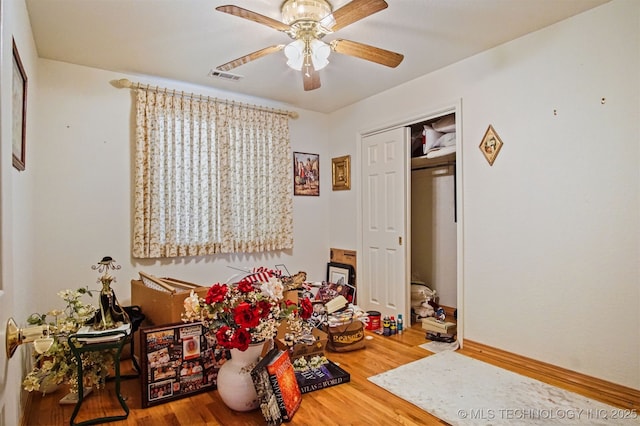 playroom featuring visible vents, baseboards, wood finished floors, and a ceiling fan