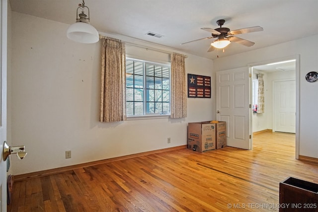 unfurnished bedroom featuring visible vents, baseboards, and hardwood / wood-style flooring