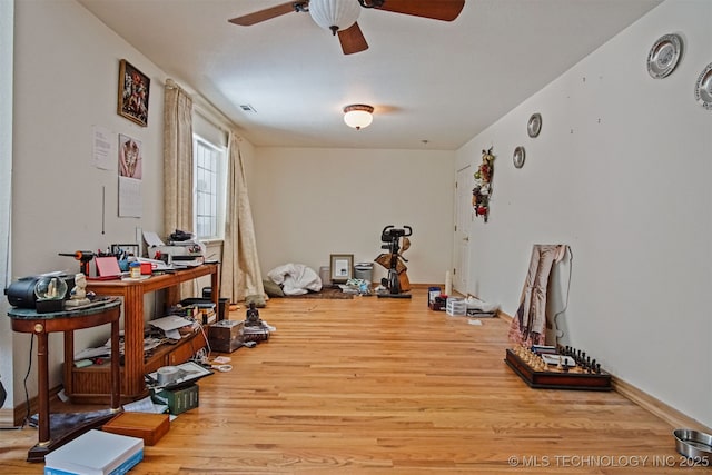 interior space featuring a ceiling fan, wood finished floors, and visible vents