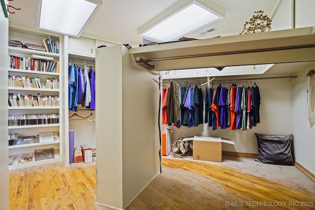 walk in closet featuring wood finished floors