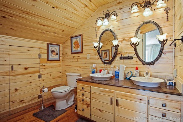 full bath featuring wooden ceiling, wooden walls, lofted ceiling, and a sink