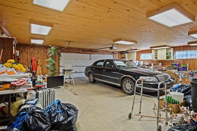 garage with wooden ceiling, a garage door opener, and wood walls