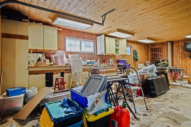 misc room with unfinished concrete flooring, wooden walls, and wooden ceiling