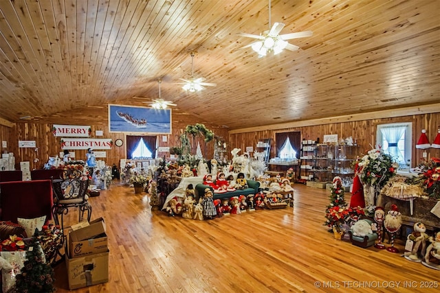 interior space featuring lofted ceiling, wood finished floors, wooden ceiling, and wood walls