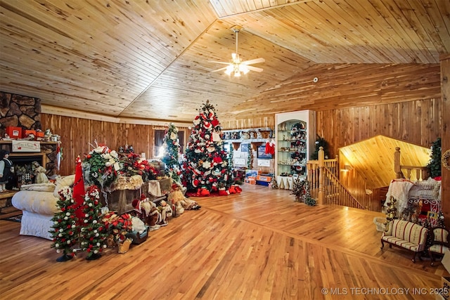 interior space featuring wooden ceiling, wooden walls, wood finished floors, and lofted ceiling