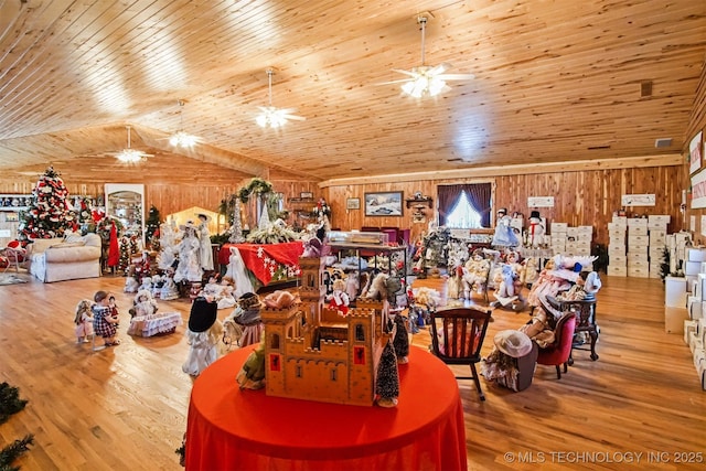 interior space featuring vaulted ceiling, wood walls, wood ceiling, and wood finished floors