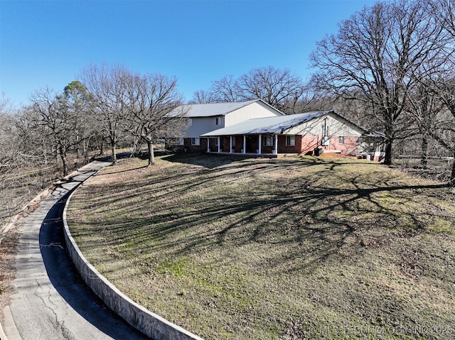 view of side of home with a yard and brick siding