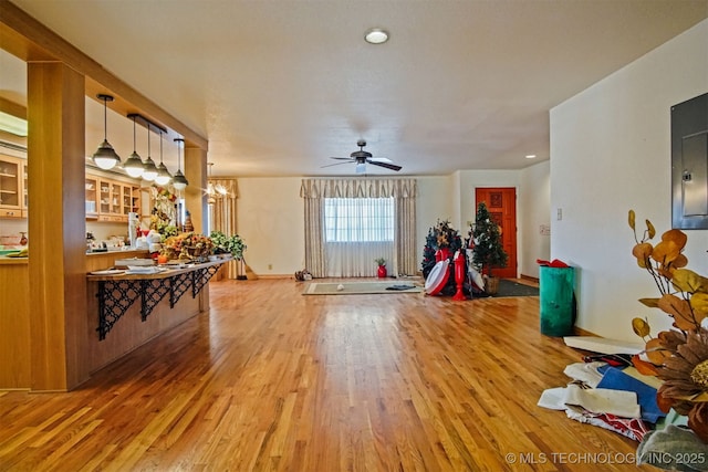 interior space with light wood finished floors and ceiling fan