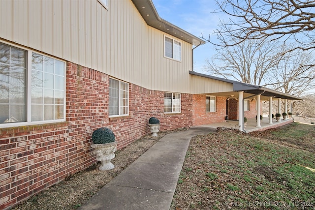 view of home's exterior featuring a patio and brick siding