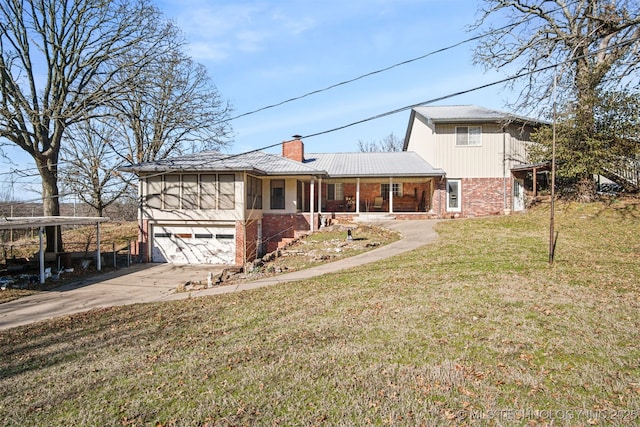 view of front of house with brick siding, a front lawn, concrete driveway, a chimney, and a garage