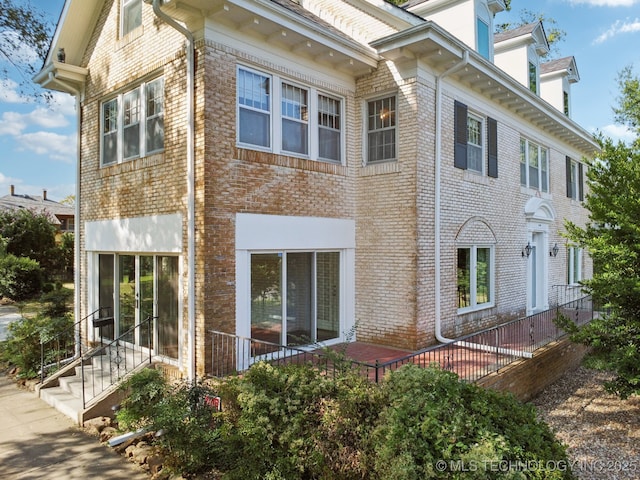 exterior space featuring brick siding