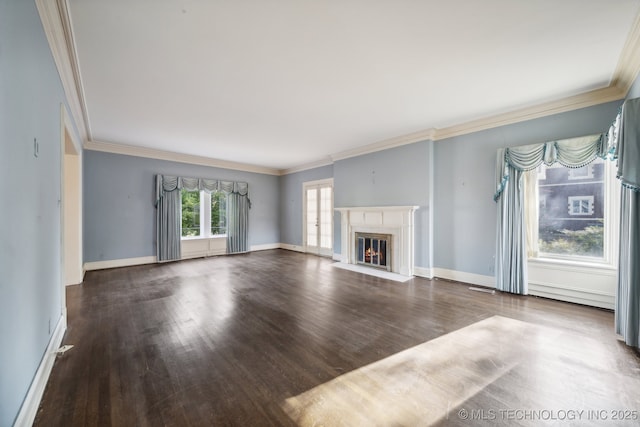 unfurnished living room with a fireplace with flush hearth, crown molding, baseboards, and wood finished floors