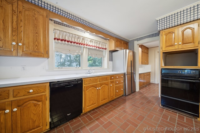 1340 E 9th St, Okmulgee, OK 74447 - kitchen featuring black appliances, brick flooring, a sink, a warming drawer, and light countertops