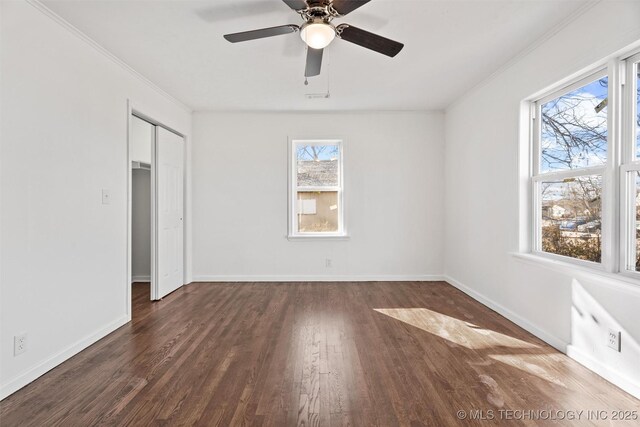 unfurnished bedroom with a ceiling fan, crown molding, wood finished floors, and baseboards