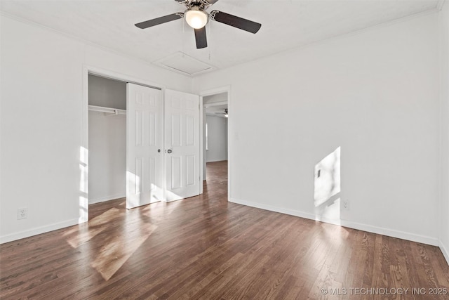 unfurnished bedroom featuring a ceiling fan, wood finished floors, a closet, and baseboards