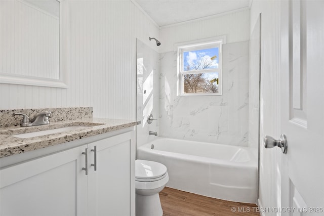 bathroom with tub / shower combination, toilet, wood finished floors, and vanity