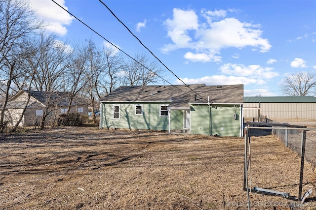 back of property featuring fence