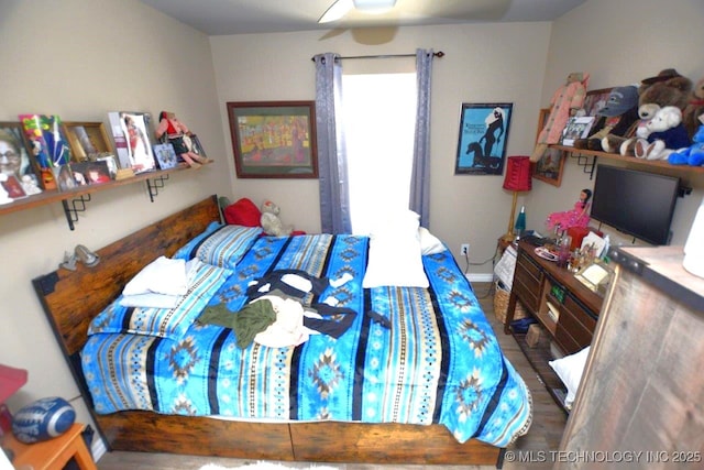 bedroom featuring wood finished floors