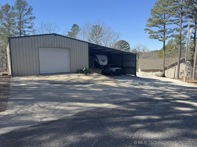 garage with a detached garage and driveway