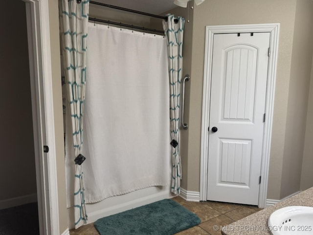 full bath with shower / bath combination with curtain and tile patterned flooring