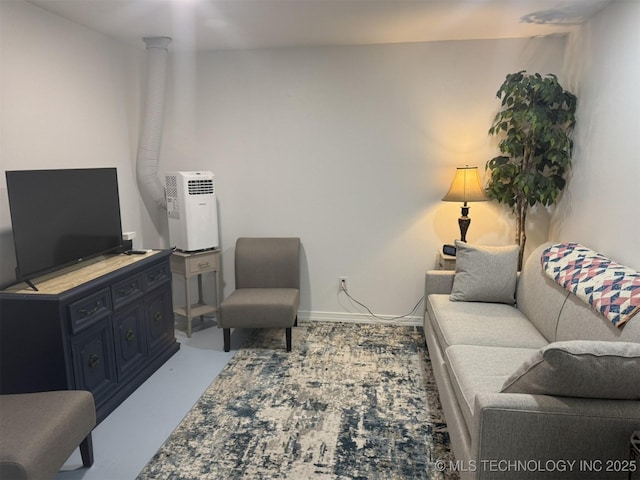 living area featuring baseboards