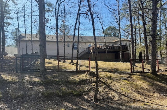 view of yard with a gate, stairs, a deck, and fence