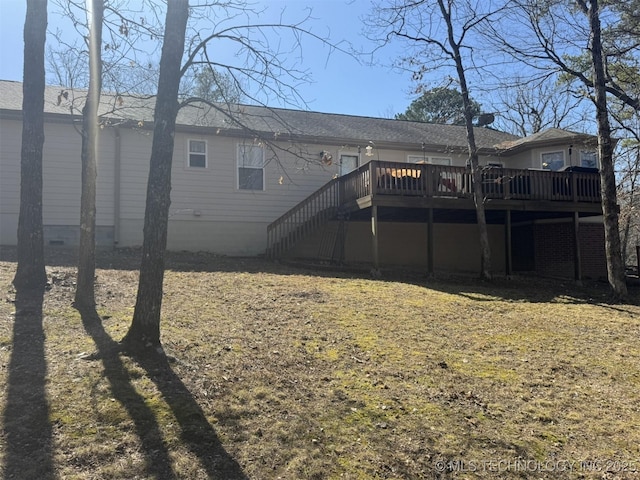 back of property featuring a deck, stairway, and crawl space