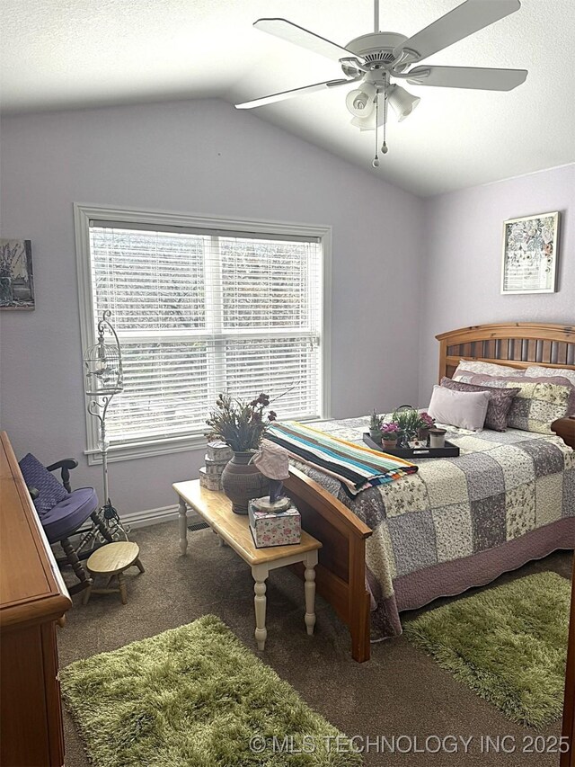 carpeted bedroom featuring lofted ceiling and ceiling fan